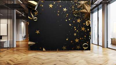 New Years Eve corner border banner of glittery gold stars, streamers, decorations and noisemakers. Top view on a black background. Wall mural