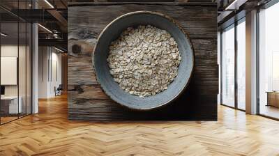 oats in a plate isolated on a wooden table Wall mural