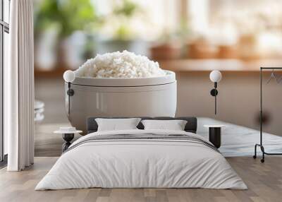 Rice cooker in a white bowl isolated on a wooden table Wall mural