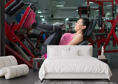 Brunette doing the leg press Wall mural