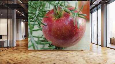 Fresh red apples and rosemary on a table Wall mural