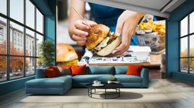 Girl eating burger in the restaurant Wall mural