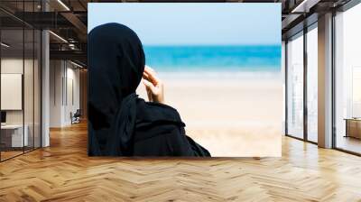 muslim woman on the beach back view Wall mural