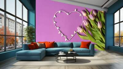 Purple tulips with a heart shape on matching background arrangement top view Wall mural