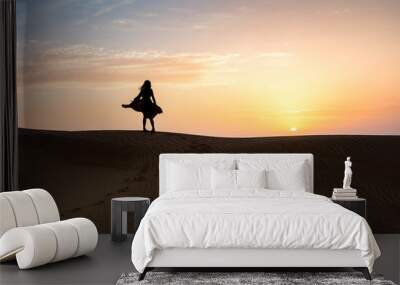 Woman in the desert with sunset view Wall mural