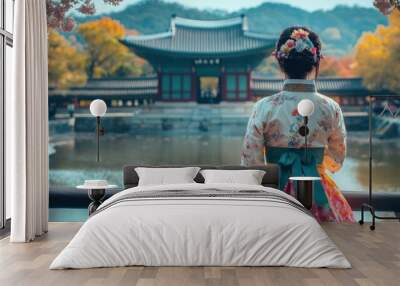 Woman in Traditional Korean Dress Admires a Tranquil Garden Wall mural