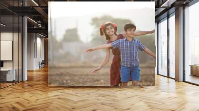 Happy children having fun in agricultural field Wall mural