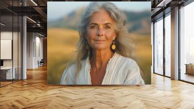 A woman with long hair and gold earrings is smiling Wall mural