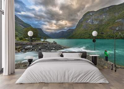 Child fishing in lake Oldevatnet of Jostedalsbreen valley Wall mural