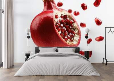 A whole pomegranate, with several arils (seeds) floating around it, some arils exposed and some inside, creating a vibrant scene, isolated on a white background Wall mural