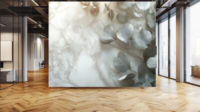 close up of silver eucalyptus leaves against marble background creates serene and elegant atmosphere. soft textures and colors evoke sense of calm and natural beauty Wall mural