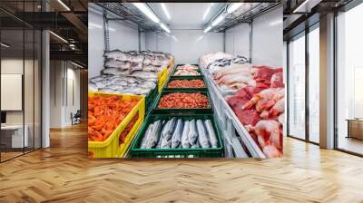 A wide-angle view of a modern cooling room stocked with crates of freshly caught seafood, organized neatly by type and size Wall mural