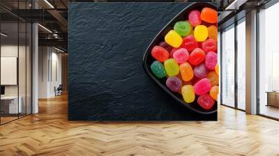 Tray with Halloween-themed candies, gothic background, spooky vibe Wall mural