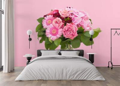 Beautiful bouquet flowers in glass vase floating on pink background, minimal design Wall mural