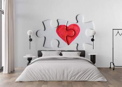 Love puzzle. Pieces of a puzzle with half of a red heart drawn on each piece, fitting perfect together. Wall mural