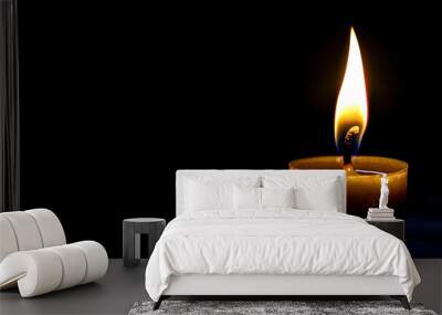 Burning candle on a black background Wall mural