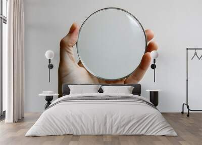 A Hand Holding a Circular Mirror Against a Minimalist Background Wall mural