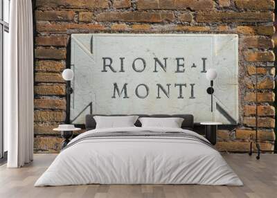 'Rione Monti', the first and most ancient district of Rome historic center, old marble slab as road sign on a brick wall Wall mural