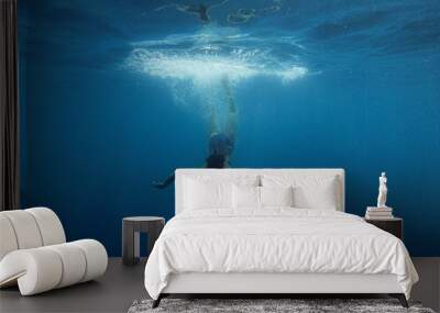 girl dives into the blue water Wall mural