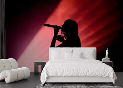 Silhouette of an unrecognizable female singer Wall mural