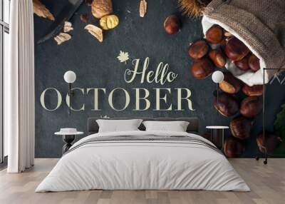 Hello october card. Roasted chestnuts on a rock table. Wall mural