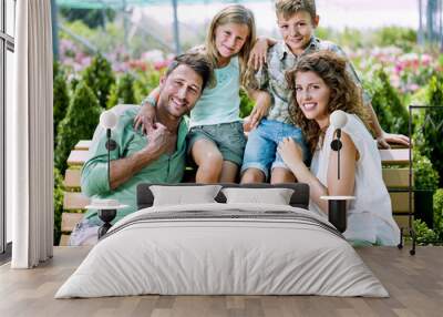 family having fun with in a greenhouse Wall mural