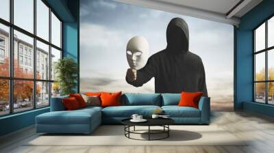 surreal image of a man with obscured face showing his mask, concept of playing with the different personalities of one's character Wall mural