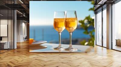 Enjoy paradise overlooking the sea. celebration with two glasses of champagne Wall mural