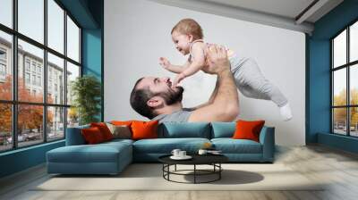 Happy father plays with his daughter at home. Wall mural