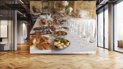 Wedding served banquet table with cold, hot appetizers. table with snacks, catering for a wedding. various snacks and drinks at the buffet table at the corporate catering event Wall mural