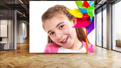 Happy smiling little girl holding a colorful toy windmill, isola Wall mural