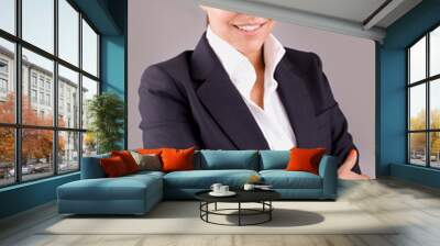 portrait of a happy young business woman standing with folded ha Wall mural