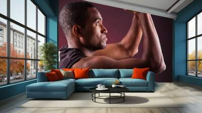 Portrait of a young male basketball player against black backgr Wall mural