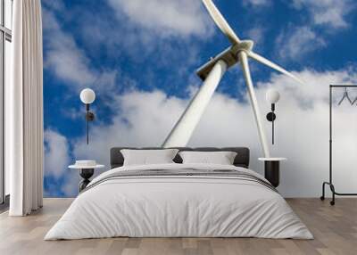 Windmill against cloudy sky Wall mural