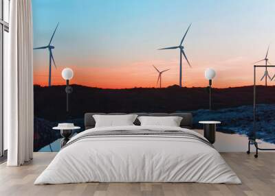 windmills at sunset in the top of a montain, whith reflexes in t Wall mural