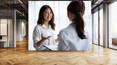 Entrepreneur Asian businesswoman discussing new business project in tablet in modern Meeting In Modern Office, Asian business casual concept. Wall mural