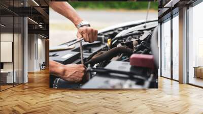 The male mechanic's hand holds the wrench In order to fix And check car engine, engineer concept and car repair Wall mural