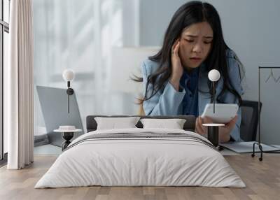 tired business woman sleepy and bored from sitting at a desk for a long time and has office syndrome Wall mural