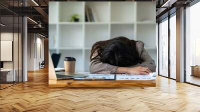 Young frustrated exhausted woman laid her head down on the table sit work at wood desk with laptop in office background. Achievement business concept of failure at work Wall mural