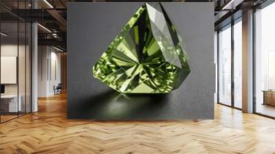 a single peridot crystal is featured on a pure grey ba background Wall mural