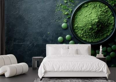 Green chlorella powder and tablets A healthy superfoods concept featuring organic food shot from above on a dark background Wall mural