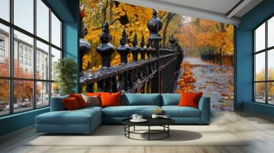 Painted forged black fence blending with autumn nature on a rainy day Wall mural