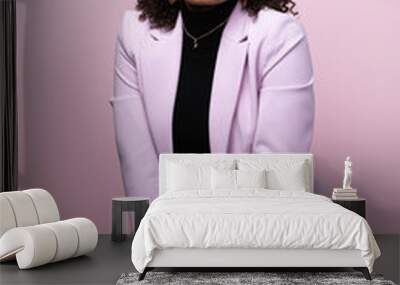 Editorial portrait of a confident young black successful business woman in a pink studio Wall mural