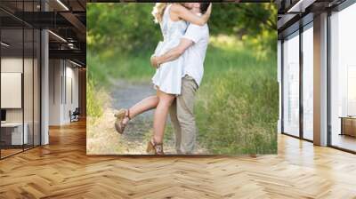 Happy young couple kissing on nature path Wall mural