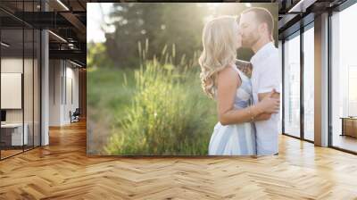 young couple kissing in sunshine Wall mural