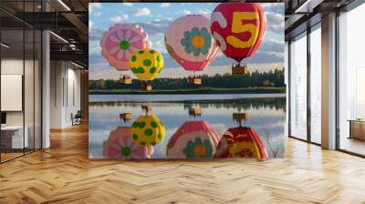 several colorful balloons are floating in the water with a sky background Wall mural