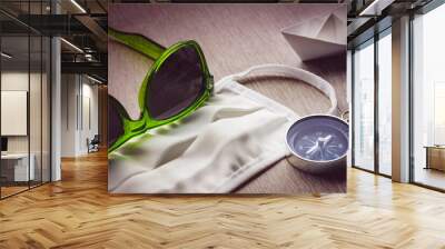 Safe Travel, mask and compass with green sunglasses Wall mural