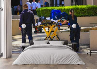 Paramedics pushing a gurny loaded with life saving equipment in Santa Barbara CA, USA Wall mural