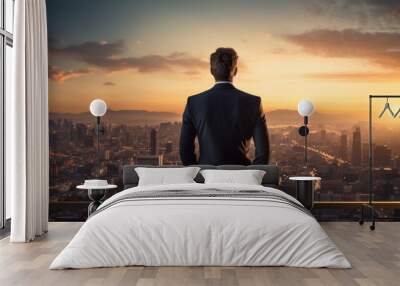 Businessman looking out over city at sunrise t Wall mural