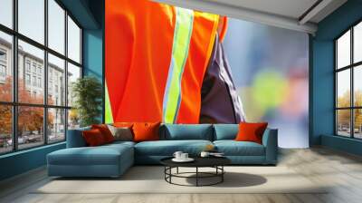 Close-up of reflective safety vest with construction site in the blurred background  Wall mural